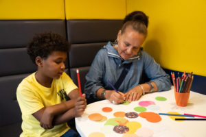 boy with woman drawing at table 