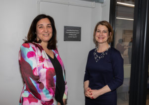 Doctor and MP stand in front of sign to mark re-opening of Crown Dale Medical Centre