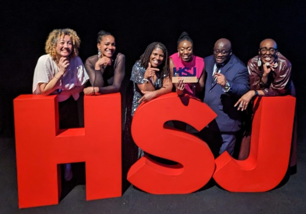 Together’s Culturally Appropriate Peer Support and Advocacy service with giant HSJ letters at award ceremony