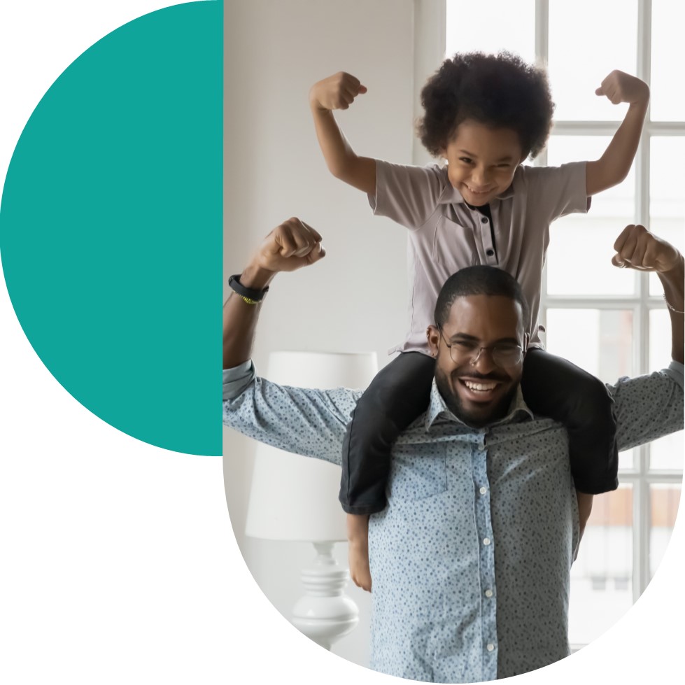 Black smiling man with young boy on shoulders 