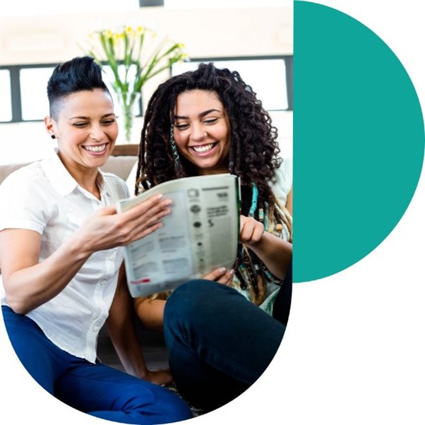 two women reading newspaper