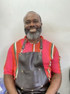 Smiling Black man in barbers' apron