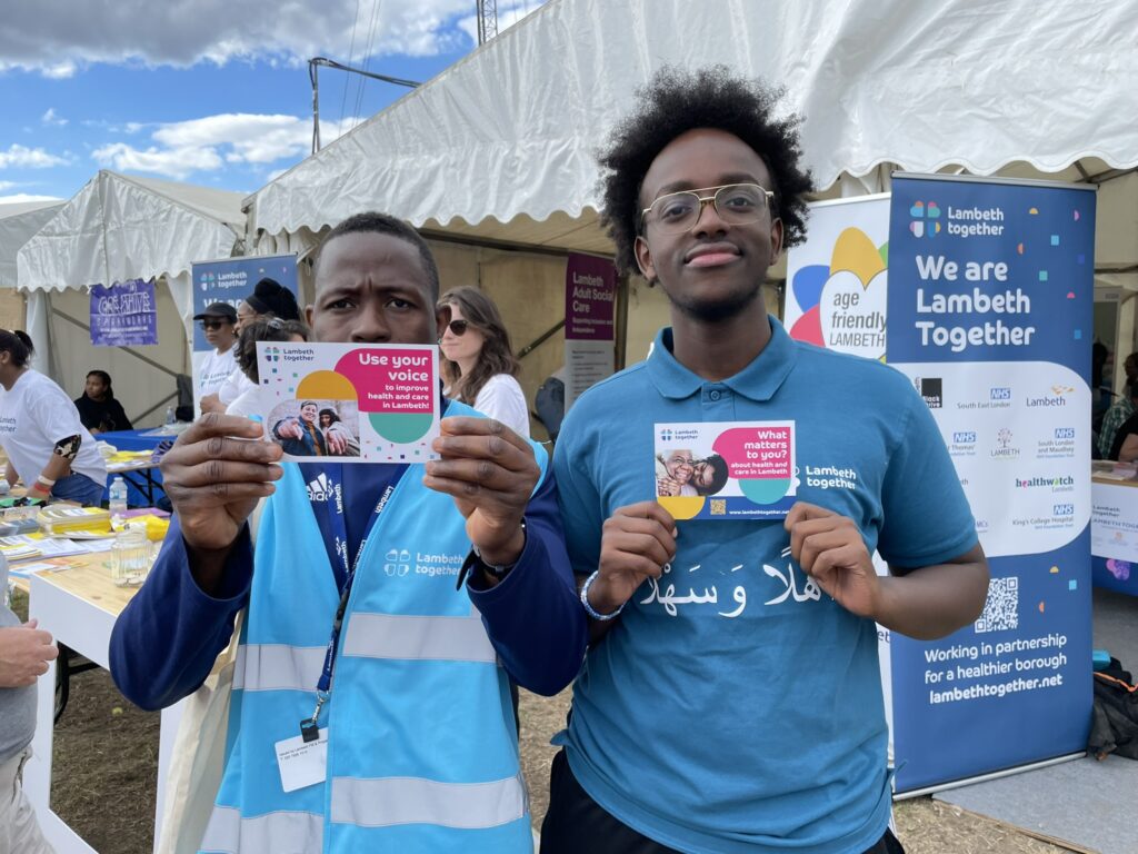 Lambeth Together team members holding the 'what matters to you' postcards to discuss health and care with residents