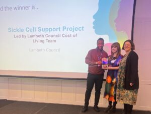 Niyah Drummonds (Financial Link Worker), Laura Stoker (Head of Tackling Poverty) collecting their award from Kate Heaps (one of the judges of the award and CEO for Community Hospice and CRO for Palliative and End of Life Care at SE London ICS)